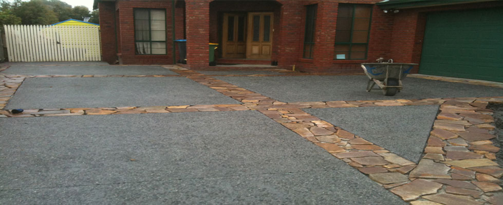 Exposed aggregate driveway with decorative stone borders